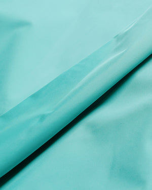 Auralee Hard Twist Polyester Satin Laminate Field Pants Turquoise Blue fabric