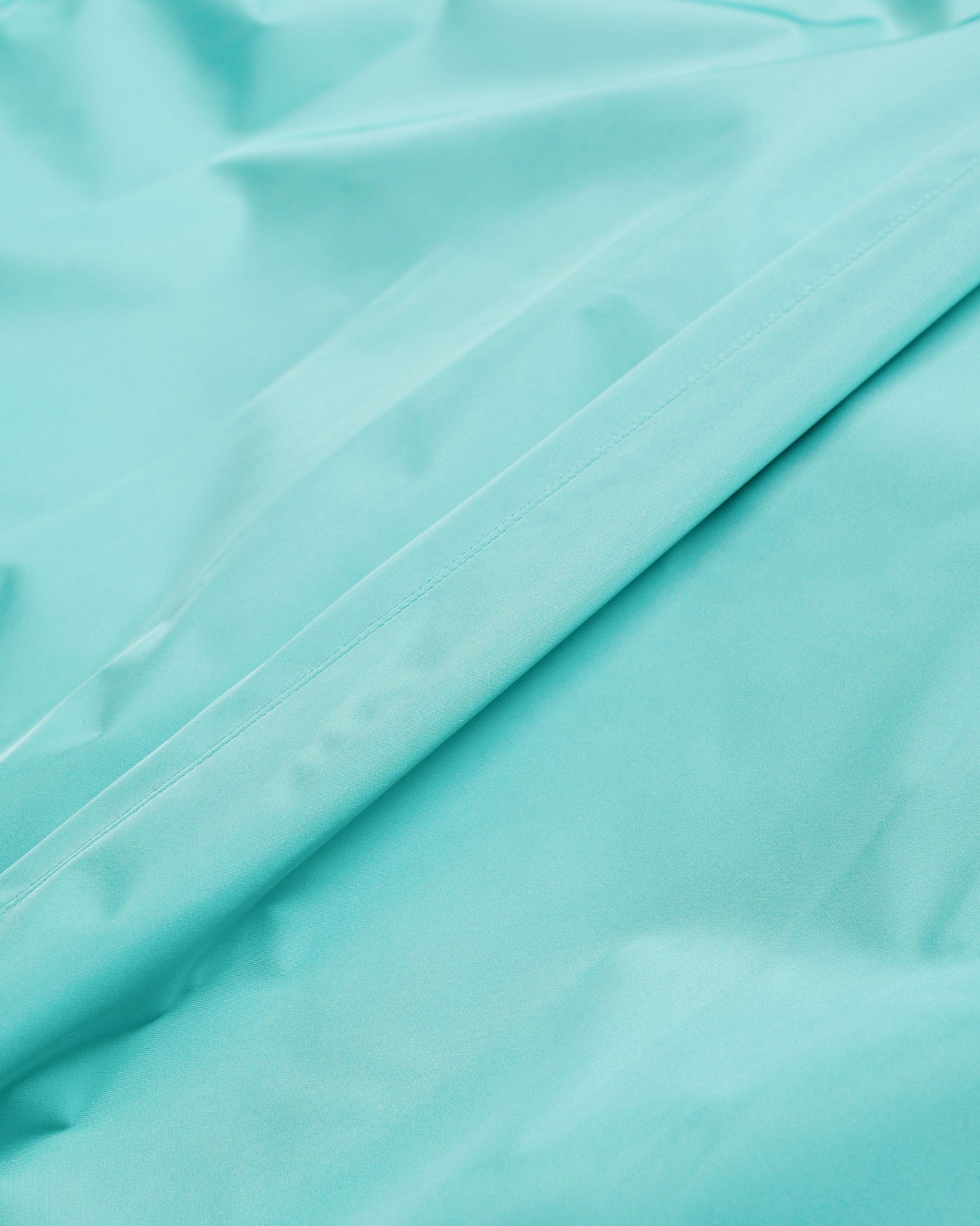Auralee Hard Twist Polyester Satin Laminate Zip Blouson Turquoise Blue fabric