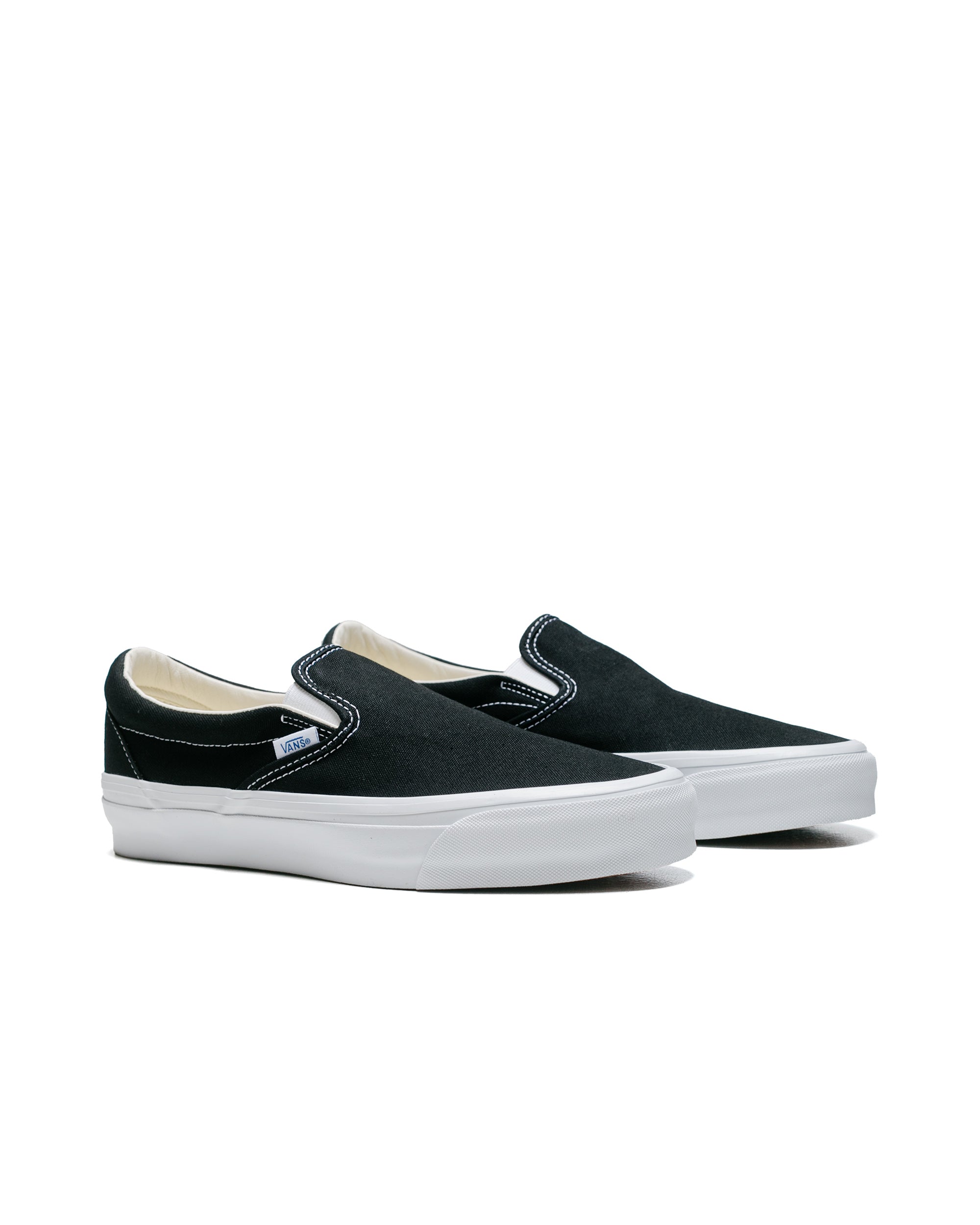 Half black half white slip on vans store